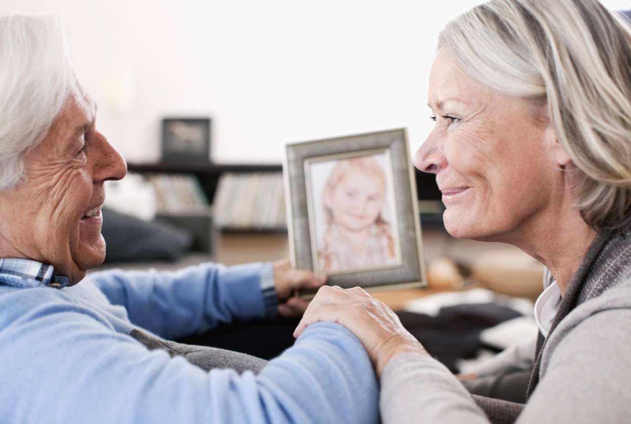 A Sentimental Christmas Gift for Senior ResidentsA Sentimental Christmas Gift for Senior Residents - The Preserve Senior couple at The Preserve smiling at their framed photo that they received for Christmas