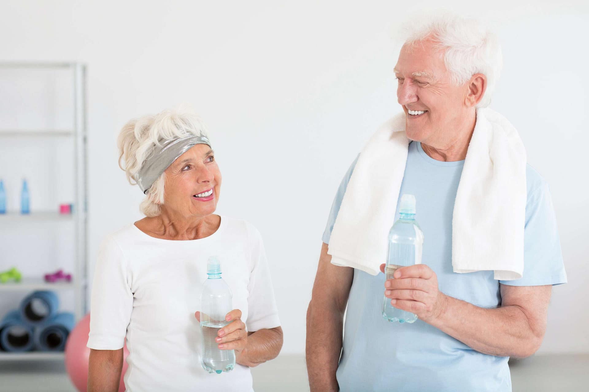 Active Senior Couple Smiling After a Workout at The Preserve - The Preserve Older man and woman smiling at each other after a workout at The Preserve, a senior living community.